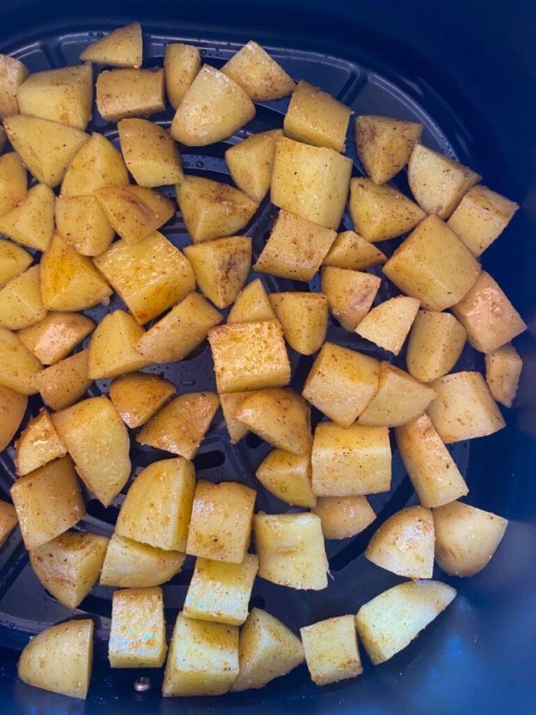cubed potatoes in air fryer basket