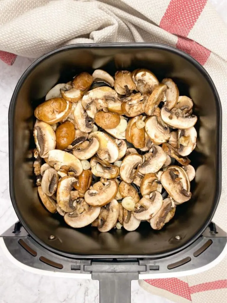 mushrooms in air fryer basket before cook