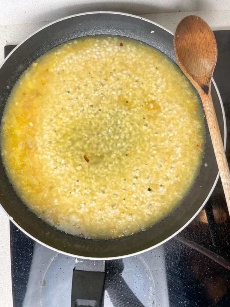 cooking process of the risotto with broth