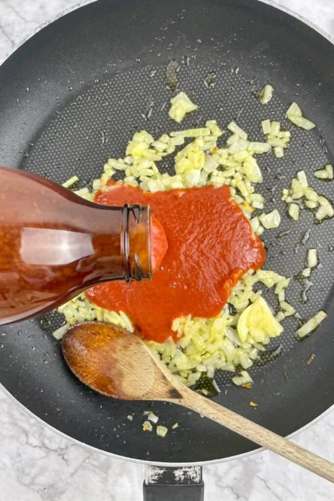 add the tomato passata to onion and garlic