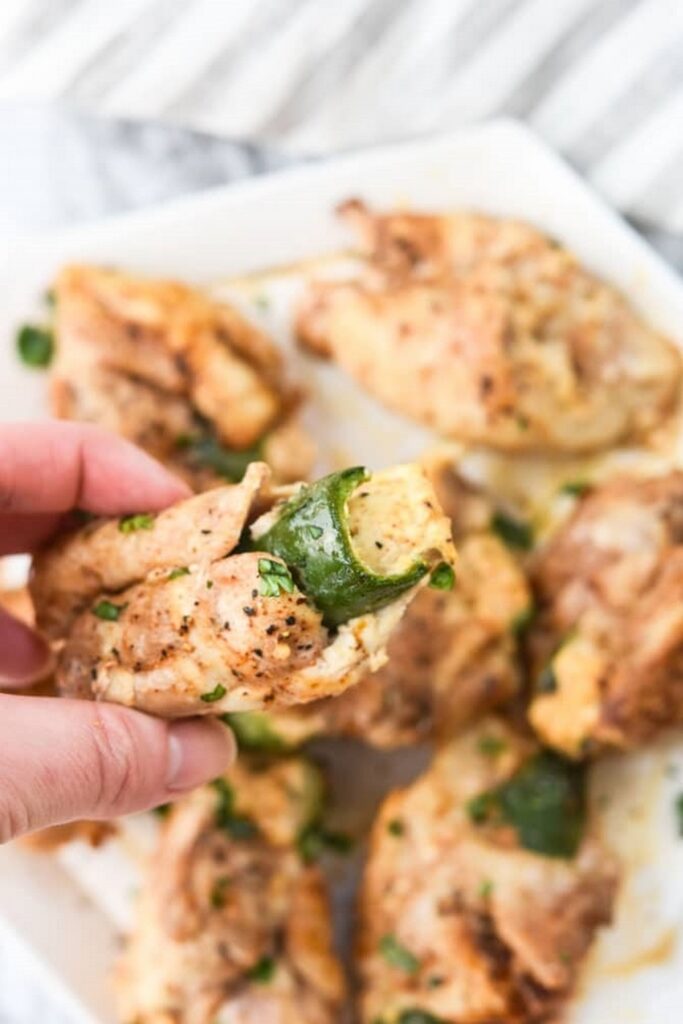 Chicken breast stuffed with zucchini on a white plate