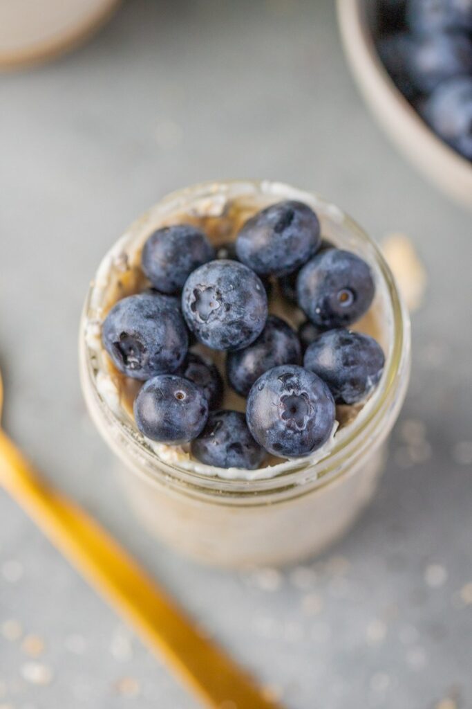 Blueberry Overnight Oats Overnight oats recipe: Jar of oats topped with fresh blueberries.