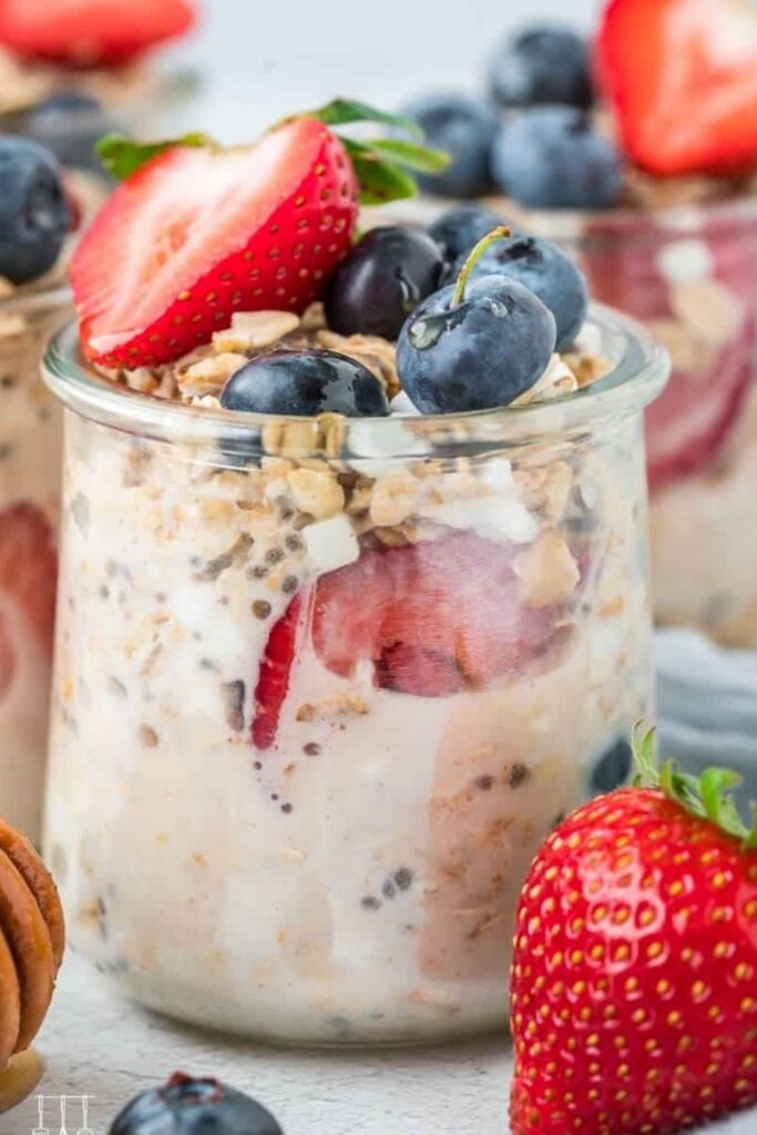 Cottage Cheese Overnight Oats Overnight oats recipe in a jar, topped with fresh strawberries and blueberries.