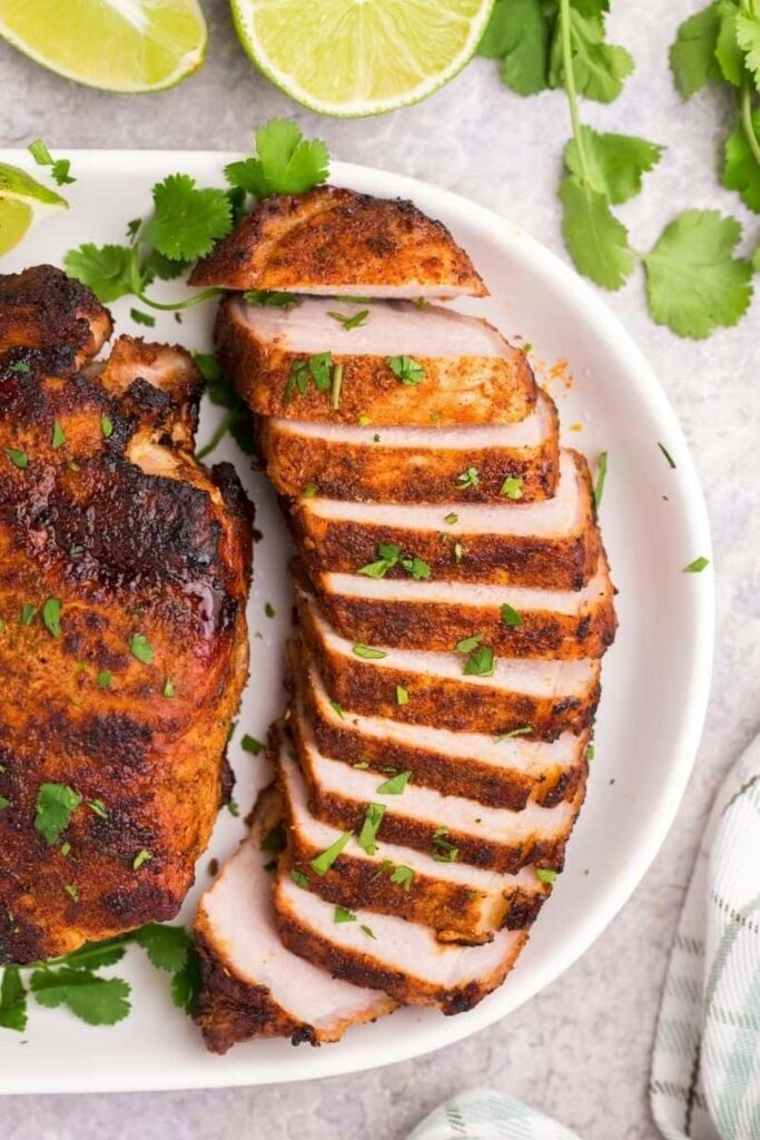 Sliced grilled pork tenderloin with cilantro and lime.