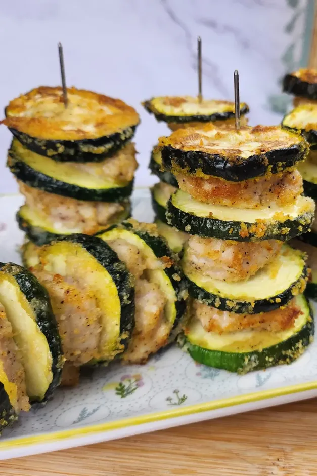 Stacks of breaded zucchini rounds layered with ground meat, skewered with toothpicks. These delicious zucchini recipes are perfect for appetizers.