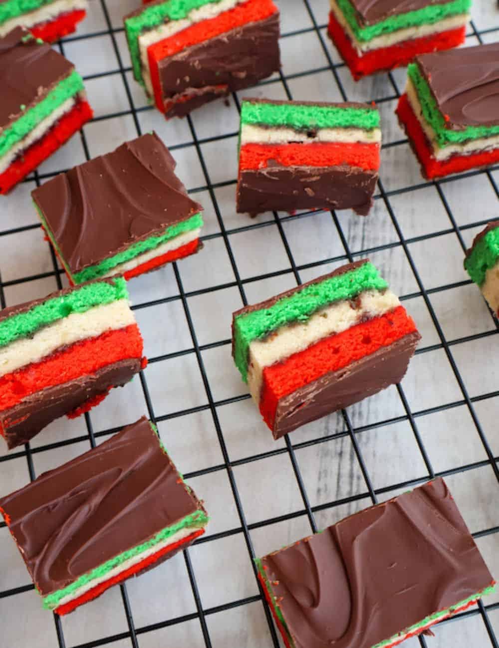 Close-up of colorful Italian rainbow cookies, layered with green, white, and red cake and topped with chocolate, perfect for gluten-free Italian recipes.